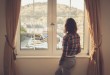 Young woman looking out the window