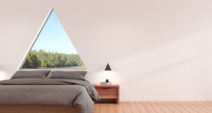View of modern bedroom with triangle window and minimal lamp on