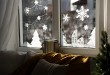 Beautiful drawing made of artificial snow on window at home. Chr