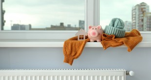 Concept of heating season with clothes on windowsill