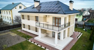 Modern residential house with solar panel system on roof.