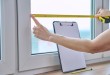 Woman measuring window with tape measure_Easy-Resize.com