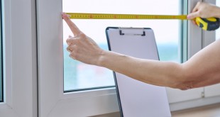 Woman measuring window with tape measure_Easy-Resize.com